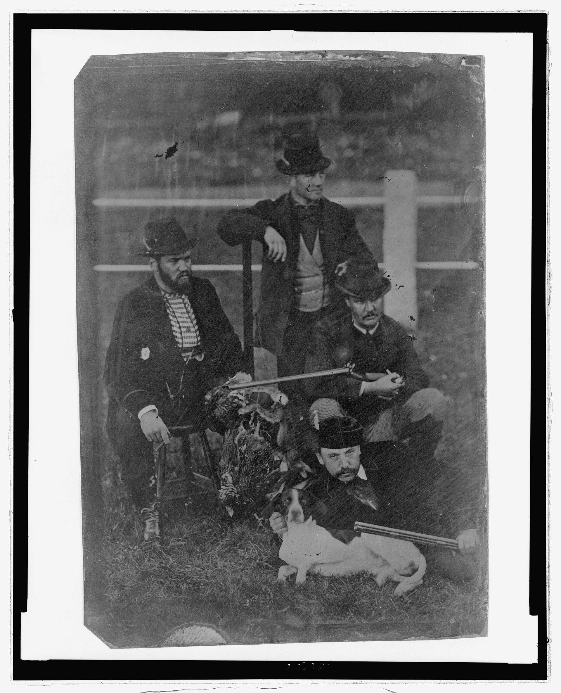 Full length of four men posed with rifles, hunting dog, and a brace of game birds LCCN2006689560
